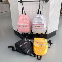 Style Japonais Harajuku Couleur Pure Transparent Couture Fille Étudiant Enfants Sac À Dos Polyvalent Personnalité Insigne De Bande Dessinée Cartable Femelle main image 4