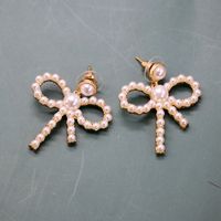Hersteller Liefern Hohle Schleifen Silberne Nadel Ohrringe Kleine Perlen Elegante Schleifen Ohrringe Süße Ohrringe main image 1