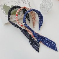 Corea Nueva Tela Streamer Carta Logo Bowknot Perla Banda Ancha Diadema Al Por Mayor Nihaojewelry main image 6