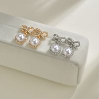 S925 Silbernadel Korea Süße Und Süße Fairy Fashion Bogen Perle Legierung Ohrringe Großhandel main image 1