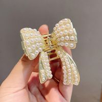 Korean Pearl Bow Tie Clip Fashionable New Temperament Hair Catching Hair Accessories Simple Disc Hair Headdress main image 2