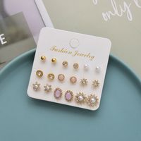 European And American Simple Alloy Pearl Diamond Geometric Round Flower Sun Combination Earrings main image 1