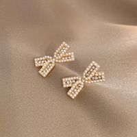 Korean Personality Pearl Earrings Bow Diamond Niche Earrings sku image 1