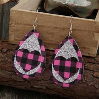 New Pink Black Grid Silver Sequined Leather Earrings Peach Heart Hollow Earrings Wholesale main image 3