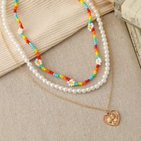 New Multi-layer Stacking Daisy Rice Beads Heart-shaped Embossed Pearl Necklace Wholesale main image 1
