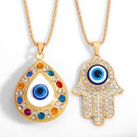 سبائك سريعة أوروبية وأمريكية قلادة يد فاطمة التركية ذات العيون الزرقاء سلسلة ملابس مجوهرات مرصعة بالماس Nkt61 main image 1