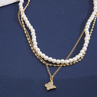 Retro Full Rhinestone Butterfly Pearl Three-layer Gold Alloy Necklace Wholesale main image 4