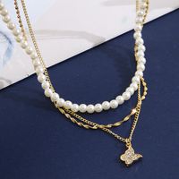 Retro Full Rhinestone Butterfly Pearl Three-layer Gold Alloy Necklace Wholesale main image 5