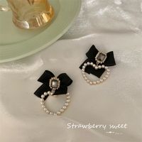 Korean Autumn And Winter New Heart Pearl Retro Bow Alloy Earrings main image 1