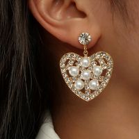 Fashion Hollow Heart Shaped Inlaid Pearl Diamond Metal Drop Earrings main image 1