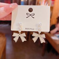 Korean Style White Bow Inlaid Pearl Alloy Earrings Wholesale main image 1