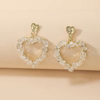 Korean Style Inlaid Crystal Heart Shaped Hollowed Alloy Stud Earrings Wholesale main image 1