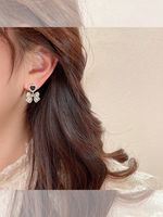 Fashion Retro Pearl Inlaid Heart Bow Shape Pendant Women's Earrings main image 3