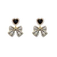 Fashion Retro Pearl Inlaid Heart Bow Shape Pendant Women's Earrings main image 5