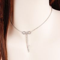 Frau Mode Einfacher Stil Bogenknoten Legierung Halskette Quaste Künstliche Strasssteine Halsketten main image 1