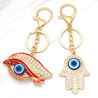 New Creative Golden Pendant Devil’s Eye Palm Inlaid Rhinestone Alloy Key Chain main image 1