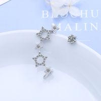 1 Pair Simple Style Shiny Star Asymmetrical Hollow Out Inlay Copper Zircon Ear Studs main image 1