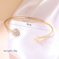 Elegante Forma De Corazón Giro Aleación Enchapado Embutido Diamantes De Imitación Oro De Rose Plateado Mujeres Pulseras De Puño sku image 2