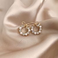 1 Pair Simple Style Classic Style Bow Knot Plating Inlay Alloy Artificial Rhinestones Artificial Pearls Gold Plated Ear Studs main image 1