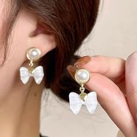 1 Paire Élégant Style Coréen Noeud D'arc Incruster Alliage Perles Artificielles Boucles D'oreilles main image 1