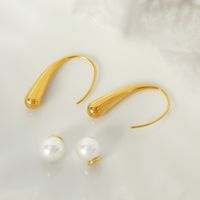 1 Pair Elegant Simple Style Commute Curve Plating Three-dimensional Inlay Titanium Steel Artificial Pearls 18k Gold Plated Ear Studs main image 1