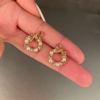 1 Pair Simple Style Circle Bow Knot Alloy Hollow Out Inlay Rhinestones Pearl Women's Ear Studs main image 1