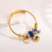 Casual Modern Style Cross Devil's Eye Palm Alloy Titanium Steel Plating Hollow Out Inlay Rhinestones Gold Plated Women's Bangle main image 4