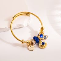 Casual Estilo Moderno Cruzar Ojo Del Diablo Palma Aleación Acero Titanio Enchapado Ahuecar Embutido Diamantes De Imitación Chapado En Oro Mujeres Brazalete sku image 1