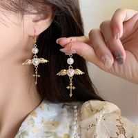 Ethnic Style Wings Alloy Plating Inlay Artificial Pearls Women's Drop Earrings Ear Clips main image 1