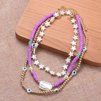 Casual Ethnic Style Star Eye Alloy Soft Clay Beaded Pearl Plating Women's Necklace main image 1