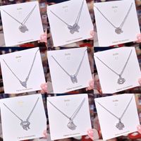 Ig Style Sweet Four Leaf Clover Butterfly Shell Titanium Steel Plating Inlay Opal Shell Zircon Pendant Necklace main image 1
