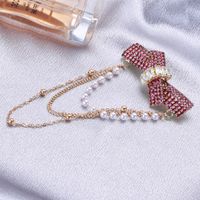 Elegant Glam Bow Knot Alloy Tassel Plating Inlay Artificial Pearls Rhinestones Women's Brooches main image 3