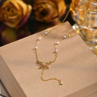 201 Stainless Steel IG Style Plating Inlay Bow Knot Artificial Pearls Pendant Necklace main image 5