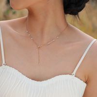 201 Stainless Steel IG Style Plating Inlay Bow Knot Artificial Pearls Pendant Necklace main image 1