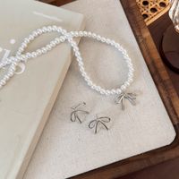 Simple Style Classic Style Bow Knot Imitation Pearl Alloy Beaded Women's Earrings Necklace main image 1