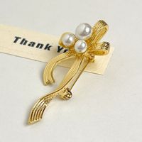 IG Style Sweet Bow Knot Metal Asymmetrical Inlay Artificial Pearls Women's Brooches sku image 1