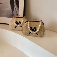 Women's Medium Straw Solid Color Bow Knot Vacation Beach Beading Clasp Frame Crossbody Bag main image video