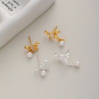 1 Pair Sweet Simple Style Bow Knot Hollow Out Inlay Sterling Silver Pearl Zircon Ear Studs main image 1