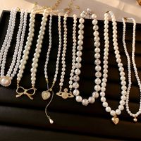 Glam Retro Heart Shape Bow Knot Imitation Pearl Beaded Plating Inlay Rhinestones Women's Layered Necklaces main image 1