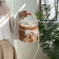 Women's Small Rattan Solid Color Vacation Beach Pearls Weave Bowknot Cylindrical String Straw Bag main image 1