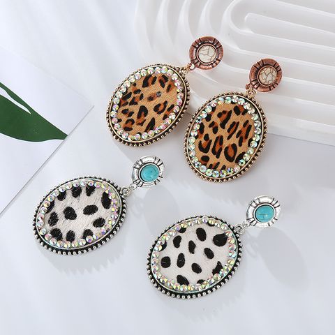 1 Pair Vintage Style Simple Style Oval Leopard Plating Inlay Pu Leather Alloy Turquoise Rhinestones Silver Plated Drop Earrings