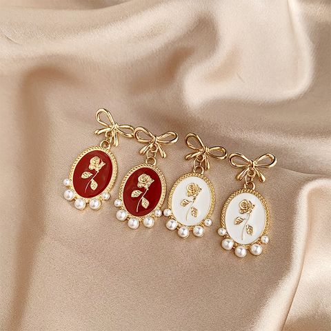 1 Pair Vintage Style Bow Knot Enamel Plating Inlay Alloy Artificial Pearls Gold Plated Drop Earrings