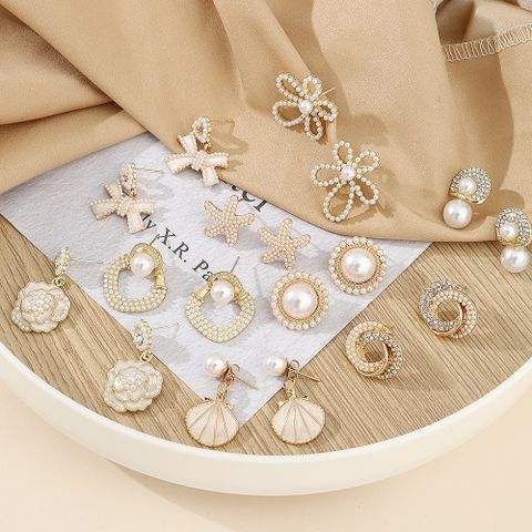 Elegant Starfish Flower Bow Knot Alloy Plating Inlay Artificial Pearls Rhinestones Gold Plated Women's Earrings