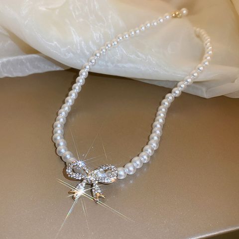 Elegant Bogenknoten Gemischte Materialien Perlen Frau Halskette Mit Anhänger