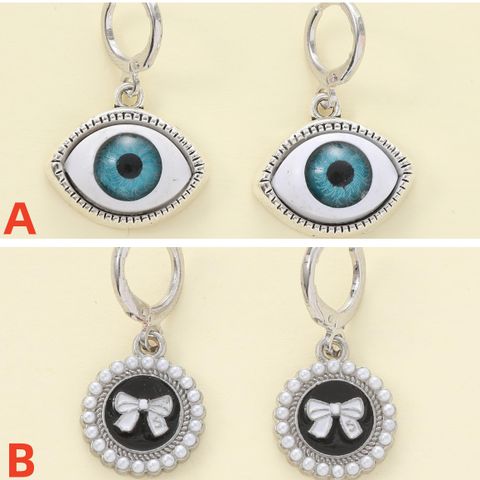 1 Pair Casual Simple Style Devil's Eye Bow Knot Asymmetrical Zinc Alloy Artificial Pearls Drop Earrings