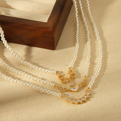 Großhandel Lässig Einfacher Stil Herzform Schmetterling Kupfer Inlay 18 Karat Vergoldet Künstliche Perlen Halskette Mit Anhänger