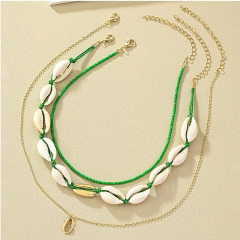Simple Style Classic Style Solid Color Alloy Shell Beaded Women's Layered Necklaces