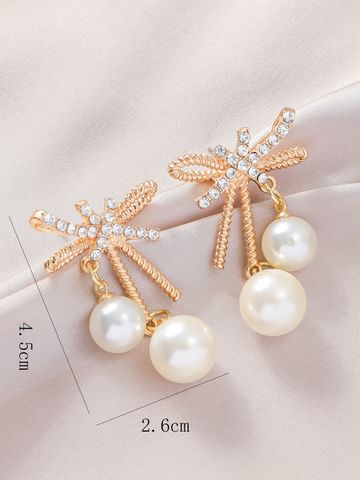 1 Pair Elegant Streetwear Bow Knot Inlay Alloy Artificial Pearls Gold Plated Drop Earrings