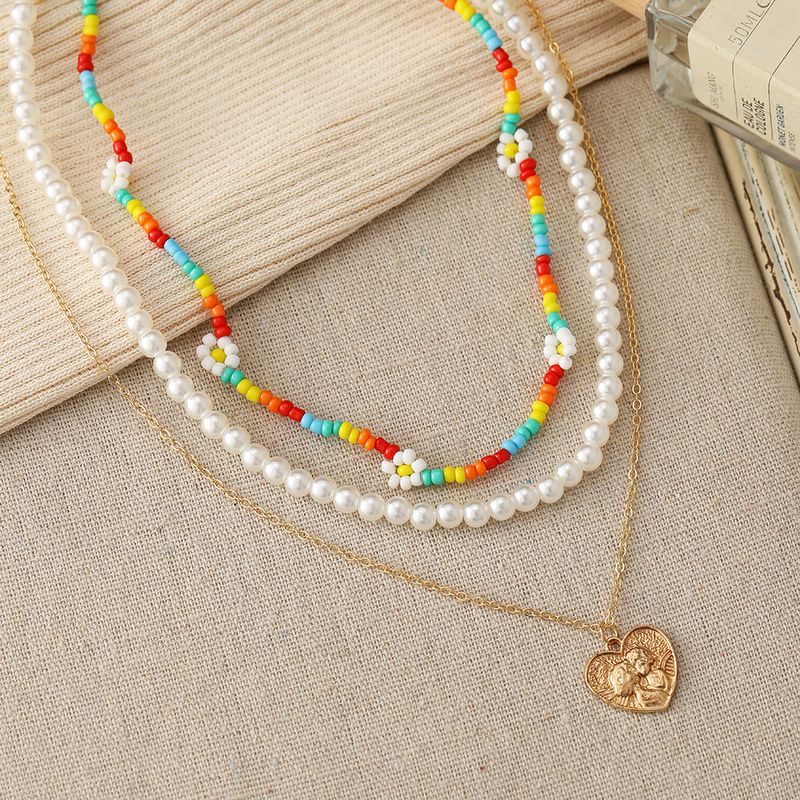 New Multi-layer Stacking Daisy Rice Beads Heart-shaped Embossed Pearl Necklace Wholesale
