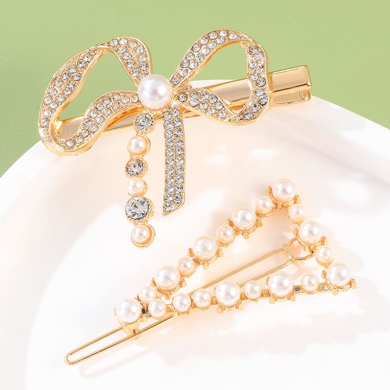 2-teiliges Mode-goldenes Vintage-perlen-strass-bogen-dreieck-haarspangen-set Für Frauen